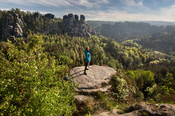 side view of a woman looking at elbe sandstone mountains, germany