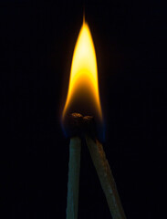 two matchstick lit on black background