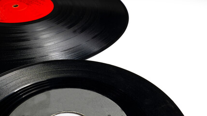 Classic vinyl record, old black color on a white background and several discs, long play and single.