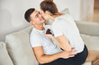 © Viacheslav Yakobchuk - Loving couple cuddling on sofa and eating chocolate cake