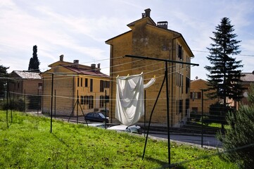 Wall Mural - A bedspread hung out to dry in the garden hanging on a wire (Gubbio, Umbria, Italy, Europe)