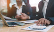 © PaeGAG - Businessmen use a calculator to calculate company financial statements for their colleagues, view and jointly solve problems within the company. Business finance and accounting concepts