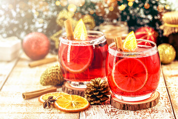 Wall Mural - hot winter drink, Christmas wine with cheerful colors and lights. Drink with cinnamon and citrus fruits. Known as mulled wine, Spanish sangria, glogg and glühwein.