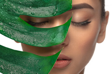 eyelids. close up portrait of beautiful young woman with monstera leaf. concept of cosmetics, makeup