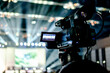 © N.Sutthisamut - tv camera in a  conference hall with spotlight