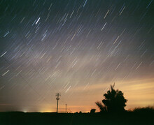 Star Trails Above Rural Road With Long Exposure Telephone Poles