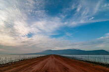 Red Dirt Road Leading Back To Land From Deep Sea Port. Kampot Province, Cambodia.