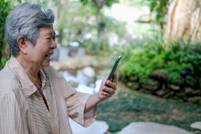 Sad Upset Old Asian Elderly Senior Elder Woman Talking On Video Call On Smart Mobile Phone