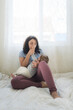 © Cavan Images - Mid-30's mom with closed eyes kissing hand of baby while breastfeeding