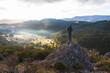 © Cavan Images - Man on the rock in the mountain watching the sunrise