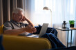 © Cavan Images - Senior male speaking with family online