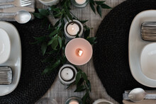Sky View Of A Large Candle On A Dinner Table Setting For Two
