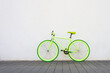 © Cavan Images - A green vintage city bicycle fixed gear on white wall