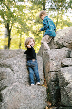 Toddler Standing On A Rock Surrounded By Boulders