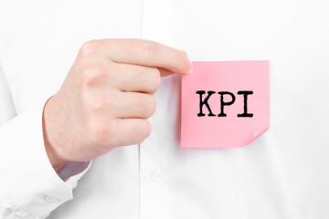 Poster - man attaches a red sticker with text kpi overlay to his white shirt