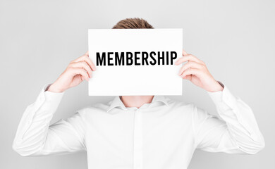 Poster - man covers his face with a white paper with text membership