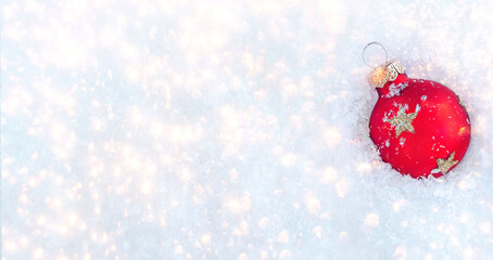 Wall Mural - abstract christmas card with red ball on a snowy white sparkling background. festive christmas decor