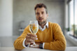 © Drazen - Close-up of businessman toasting with a glass of wine.