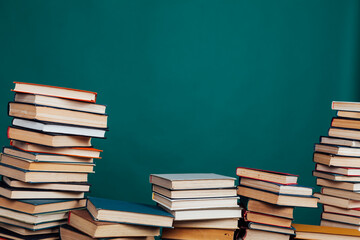 stacks of books for reading and education on a green background in the university library