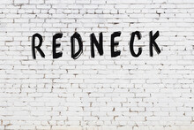 Inscription Redneck Painted On White Brick Wall
