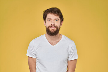 Bearded man on emotions white t-shirt fun lifestyle yellow background