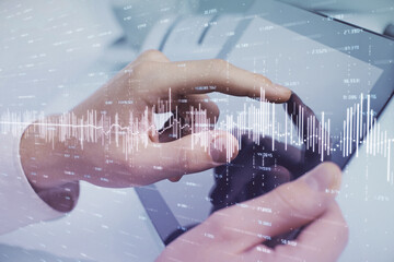 Multi exposure of man's hands holding and using a phone and financial chart drawing. Market analysis concept.