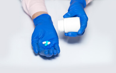 Wall Mural - Female doctor hand showing handful of capsules or pills for curing disease. Closeup of vitamins. pharmaceutical prescription