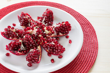 Wall Mural - Pomegranate on plate on table.  Healthy snack and natural vitamins concept. 