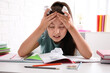 © New Africa - Emotional preteen girl at table. Doing homework