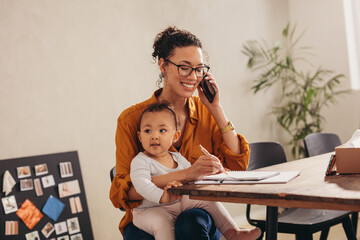 Wall Mural - Working mom with child talking on phone