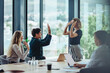 © Jacob Lund - Business people celebrating success in conference room
