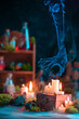 Mystical smoke hand extinguishing a candle, creepy ghost in magical still