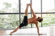 © Margo Basarab - Yoga men workout in studio, training in front of a window