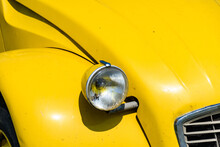 Closeup Of A Yellow Vintage Car Headlight Standing At An Exhibition