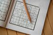 © Ridvan - sudoku (crossword) puzzle and pencil. Selective focus.