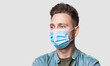 © kite_rin - Young man wearing protective face mask studio isolated portrait, social distancing, pandemic, corona virus protection, healthy lifestyle, people concept