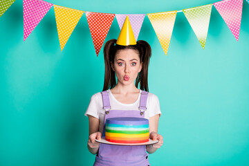 Sticker - Photo portrait of cheerful happy birthday girl wearing cone keeping cake sending air kiss isolated on bright turquoise color background