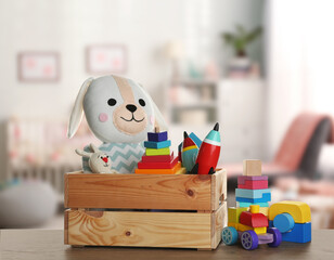 Wall Mural - Set of different cute toys on wooden table in children's room