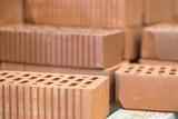 Fototapeta  - Hollow ceramic bricks. Construction industry. For construction. Sale of building materials.