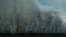 Powerful Wave Crashing Into Seawall With Huge Splashes
