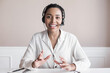 Beautiful business woman looking and speaking through the web camera while making a video conference from office or home
