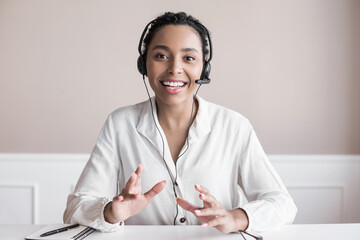 Sticker - Beautiful business woman looking and speaking through the web camera while making a video conference from office or home