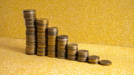 Stacks of coins with growth between stacking limits on gold background. 