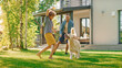 © Gorodenkoff - Handsome Father, and Son Play Catch With Loyal Family Friend Golden Retriever Dog. Family Spending Time Together Training Dog. Sunny Day Idyllic Suburban Home Backyard.