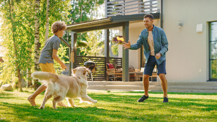 Wall Mural - Handsome Father and Son Spend Quality Family Time Together, Play Soccer with Football, Passing to Each other, and Having Fun. Sunny Day Idyllic Suburban Home Backyard with Loyal Golden Retriever Dog 