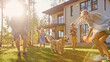 © Gorodenkoff - Beautiful Family of Four Play Catch Toy Ball with Happy Golden Retriever Dog on the Backyard Lawn. Idyllic Family Has Fun with Loyal Pedigree Dog Outdoors in Summer House Backyard.