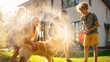 © Gorodenkoff - Father, Daughter, Son Play With Loyal Golden Retriever, Dog Tries to Catch Water from Garden Water Hose. Family Spending Fun Outdoors Time Together. Sunny Day Idyllic Suburban Home.
