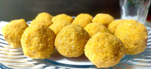 Mouth watering sweet - Besan laddoo made by roasted gram flour, ghee, dry fruits and sugar, served in a plate