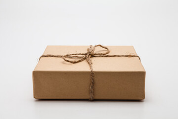 Brown parcel Kraft gift box present on white background