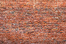 Brick Wall Made Of Old Crumbling Red Bricks Falling Out.